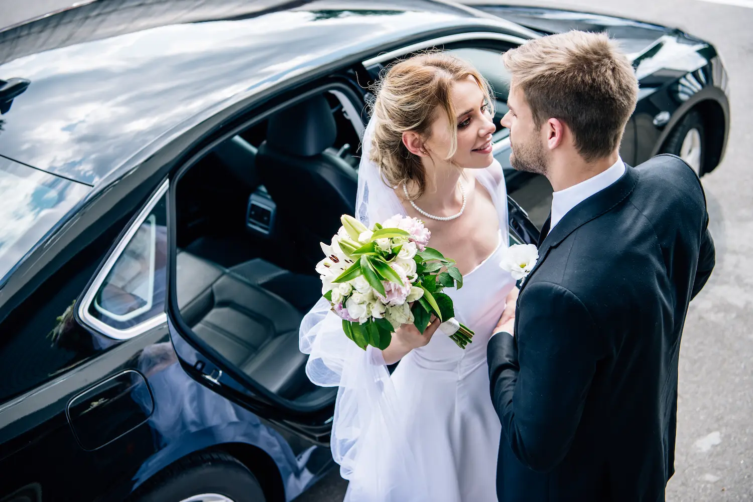 bridegroom-in-suit-kissing-attractive